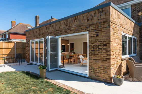 Extension with bifold doors open onto a lawn