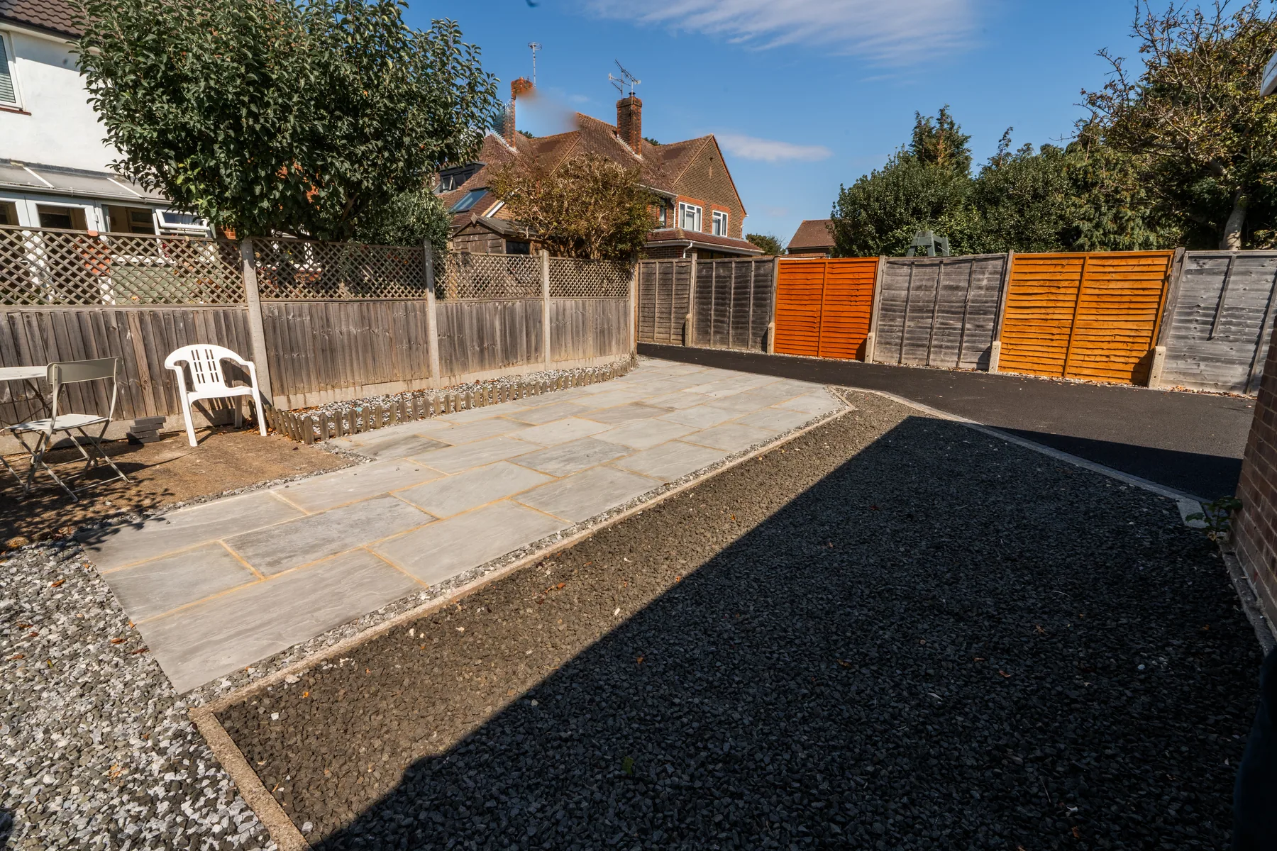 A finished driveway with a sandstone path alongside