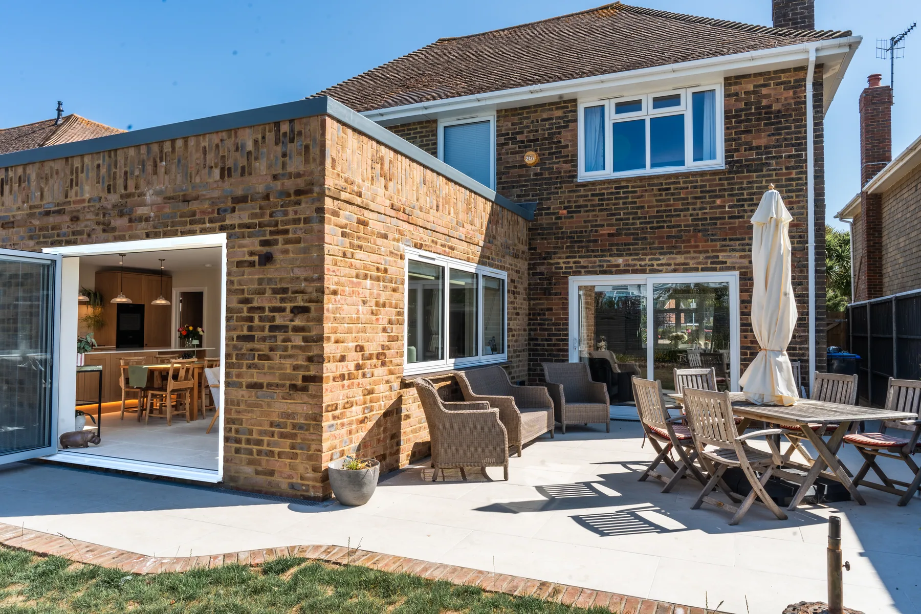A finished rear extension in West Sussex with bifold doors onto a patio